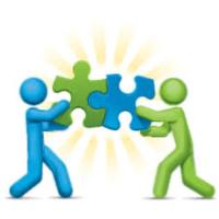 Two figures holding adjoining puzzle pieces showing teamwork.