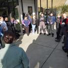 Students and teachers standing in a circle discussing the plan for the day.